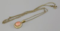 Lot 89 - An 18ct gold coral and diamond oval cluster pendant
