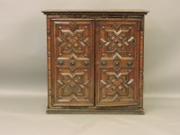 Lot 647 - A 17th century style oak carved panelled chest