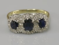 Lot 34 - An 18ct gold sapphire and diamond triple cluster ring