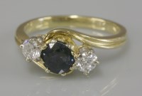 Lot 94 - An 18ct gold sapphire and diamond three stone crossover ring