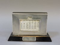 Lot 308 - A silver and ebonised wooden desk calendar