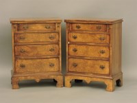 Lot 708 - A pair of reproduction figured walnut bachelor's chests of drawers