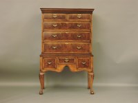 Lot 710 - A Queen Anne style walnut and crossbanded chest on stand