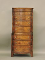 Lot 716 - A reproduction walnut bow front chest on chest