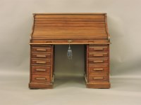 Lot 782 - An early 20th century oak roll top desk