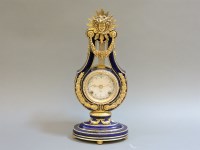 Lot 584 - A reproduction 'Marie Antoinette' china and gilt metal mounted mantel clock