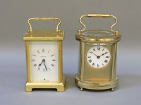 Lot 185 - An oval cased carriage clock