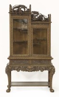 Lot 391 - A finely carved Display Cabinet