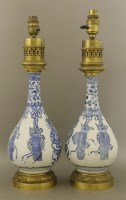 Lot 423 - A pair of blue and white bottle vases