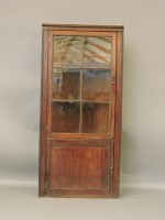 Lot 511 - A Georgian mahogany floor standing corner cabinet