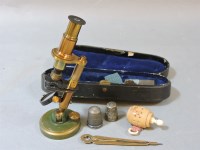 Lot 168 - A cased student's brass folding microscope