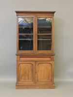 Lot 521 - A Victorian mahogany bookcase on cupboard