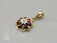 Lot 20 - A 9ct gold illusion set diamond and ruby cluster pendant
