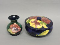 Lot 227 - A Moorcroft 'Hibiscus' pattern pot and cover