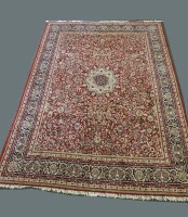 Lot 561 - A large red ground rug