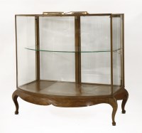 Lot 401 - A walnut bow front shop display cabinet