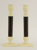 Lot 57 - A pair of ivory and composition candlesticks