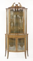 Lot 448 - An Edwardian inlaid satinwood serpentine display cabinet