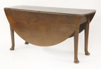 Lot 327 - An George III oak drop-leaf dining table