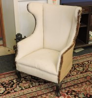 Lot 457 - A 19th century barrel wing back armchair