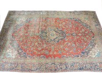 Lot 358 - A red ground wool carpet