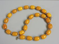 Lot 54 - A single row bakelite barrel and silver plated bead necklace