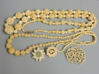 Lot 59 - A single row of graduated carved ivory flower head bead and beads