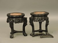 Lot 436 - A pair of Chinese carved hardwood urn stands