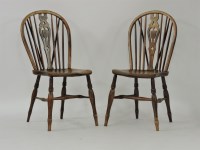 Lot 451 - A pair of elm shield back kitchen chairs