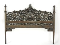 Lot 522 - A French Gothic walnut head board