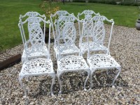 Lot 545 - A set of six white painted aluminium garden chairs