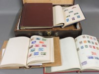 Lot 217 - A wooden case containing seven all world stamp albums