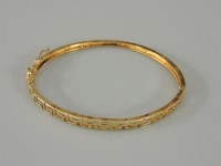 Lot 7 - A Continental gold Greek key hinged bangle