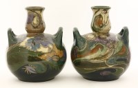 Lot 42 - A pair of Gouda bottle vases