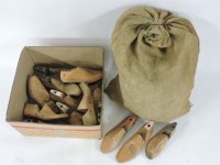 Lot 235 - A box and a sack of carved wooden shoe lasts