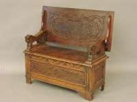 Lot 437 - An oak carved monk's bench