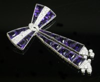 Lot 409 - An Art Deco amethyst and diamond geometric style bow brooch