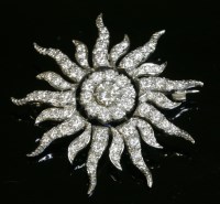 Lot 545 - An 18ct gold diamond set sunburst brooch