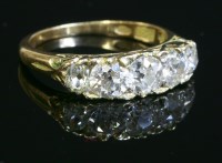 Lot 329 - A late Victorian five stone graduated diamond carved head ring