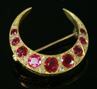 Lot 332 - An Edwardian ruby and diamond closed crescent brooch