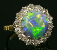 Lot 503 - A black opal and diamond circular cluster ring