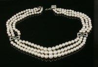 Lot 415 - A late Art Deco three-row cultured pearl