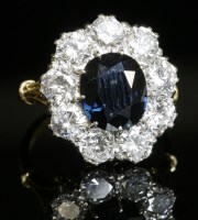 Lot 546 - A sapphire and diamond oval cluster ring