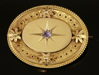 Lot 311 - A Victorian diamond set Etruscan Revival gold shield-style brooch