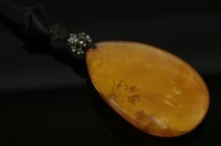 Lot 286 - A pear-shaped double-sided amber pendant