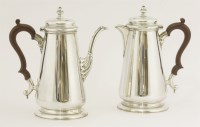 Lot 182 - A pair of silver café au lait pots