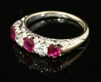 Lot 334 - A late Victorian five stone ruby and diamond carved head ring