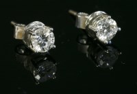 Lot 572 - A pair of white gold single stone diamond stud earrings