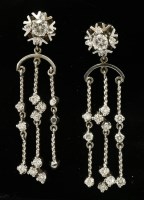 Lot 551 - A pair of white gold diamond cluster drop earrings