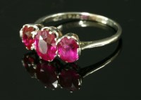 Lot 438 - An Art Deco three stone ruby and synthetic ruby ring